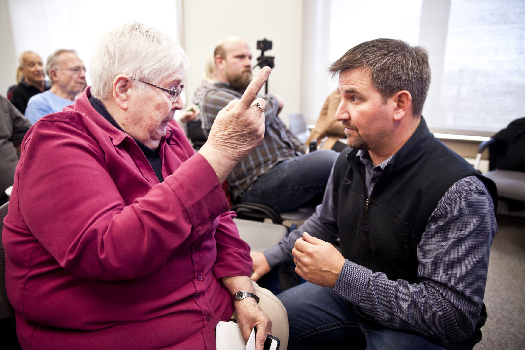 Meeting attendees talk before a public meeting with EPA officials in Butte